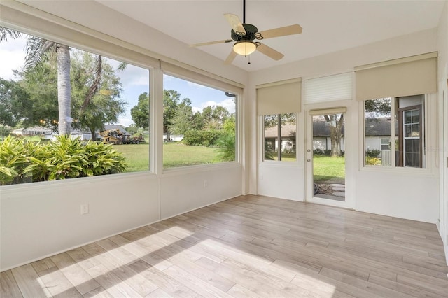 unfurnished sunroom featuring ceiling fan