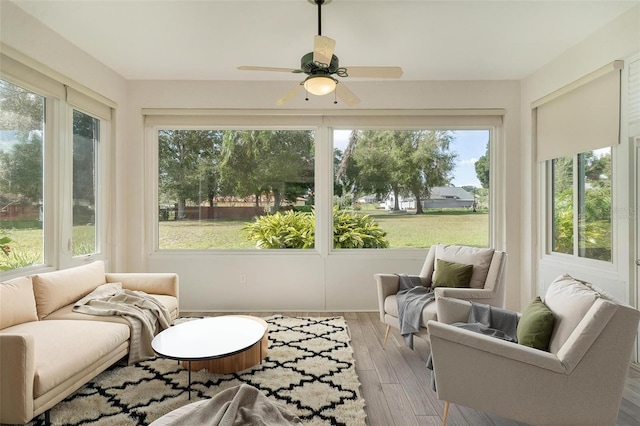 sunroom featuring ceiling fan