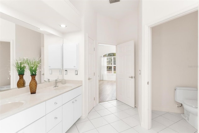 bathroom featuring vanity, tile patterned floors, and toilet