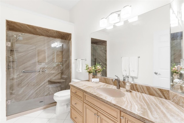 bathroom featuring vanity, toilet, an enclosed shower, and tile patterned flooring