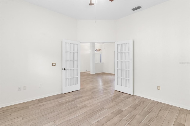 spare room with french doors, ceiling fan, and light hardwood / wood-style flooring