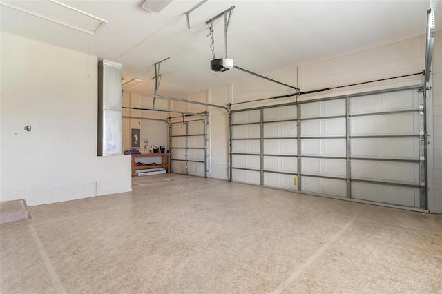 garage featuring a garage door opener and electric panel