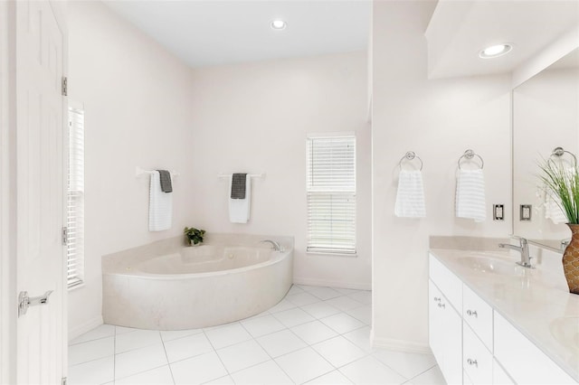 bathroom featuring tile patterned floors, vanity, and a bath