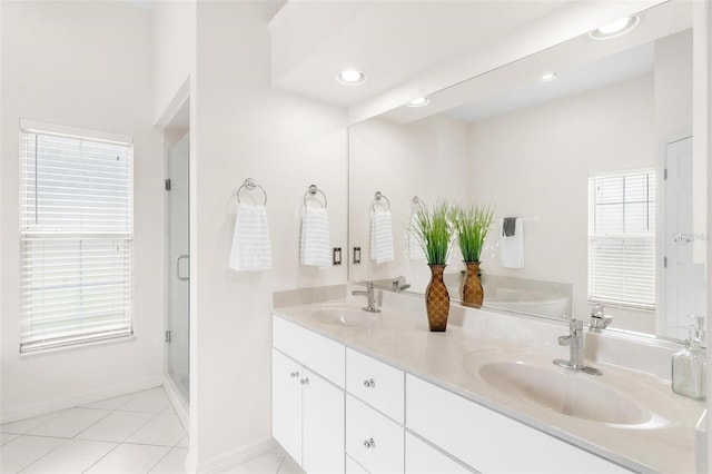 bathroom with walk in shower, tile patterned floors, and vanity