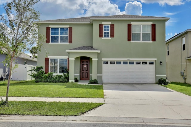 view of front of property featuring a front yard and a garage