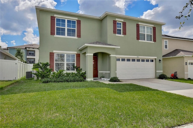 view of front of property with a garage and a front lawn