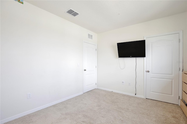 unfurnished bedroom featuring light colored carpet