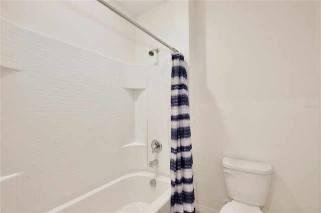 bathroom featuring toilet and shower / bath combo with shower curtain