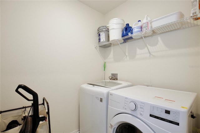 clothes washing area with separate washer and dryer