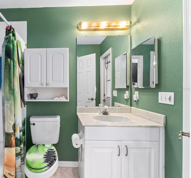 bathroom featuring tile patterned floors, curtained shower, vanity, and toilet