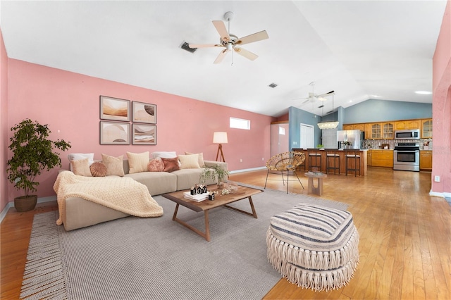 living room featuring light wood-type flooring, ceiling fan, and lofted ceiling