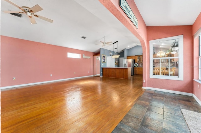 unfurnished living room with dark wood-type flooring, ceiling fan, and lofted ceiling