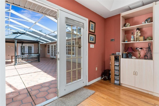 doorway with french doors and light hardwood / wood-style flooring