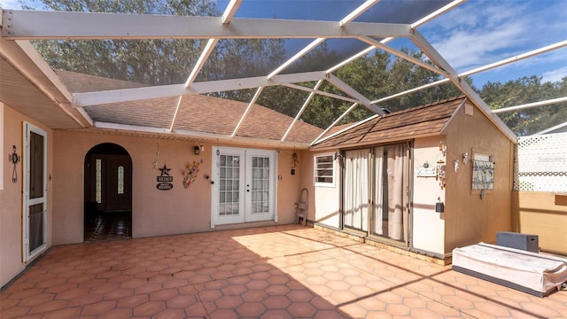 view of patio / terrace featuring glass enclosure and french doors