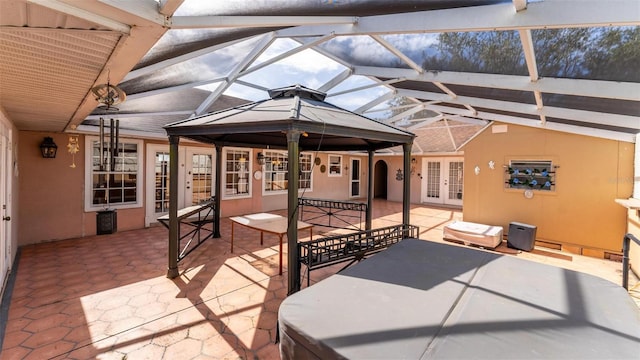 view of patio featuring a lanai and french doors