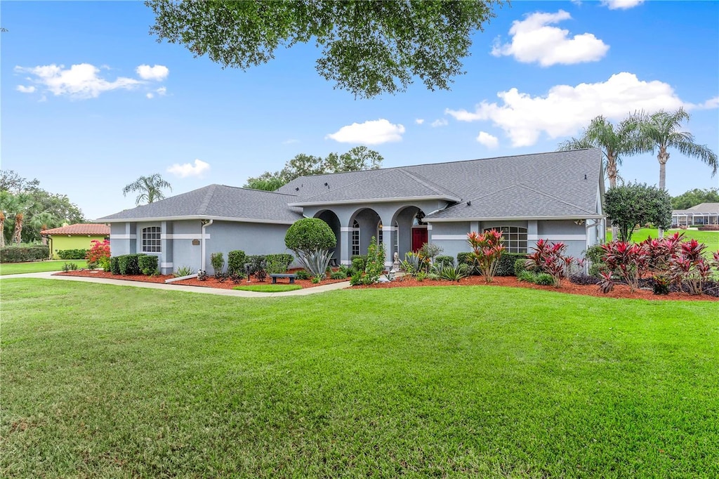 ranch-style home featuring a front yard