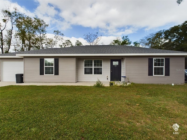 ranch-style house with a garage and a front yard