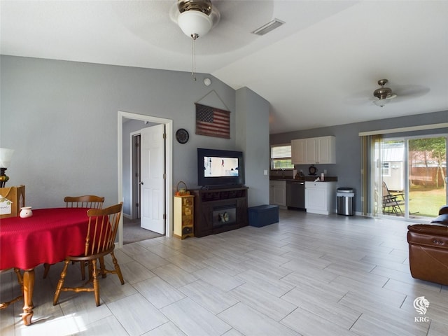 living room with ceiling fan, sink, and vaulted ceiling