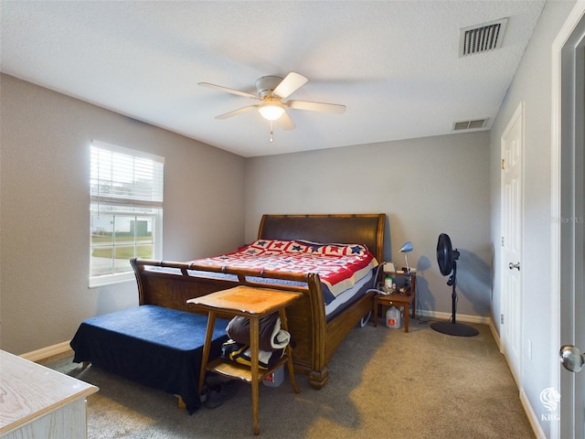 bedroom with carpet, a textured ceiling, and ceiling fan