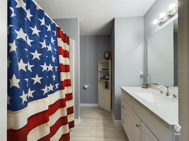 bathroom featuring vanity and a textured ceiling