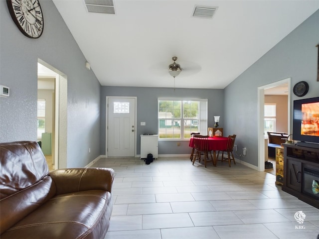 tiled living room featuring vaulted ceiling and ceiling fan