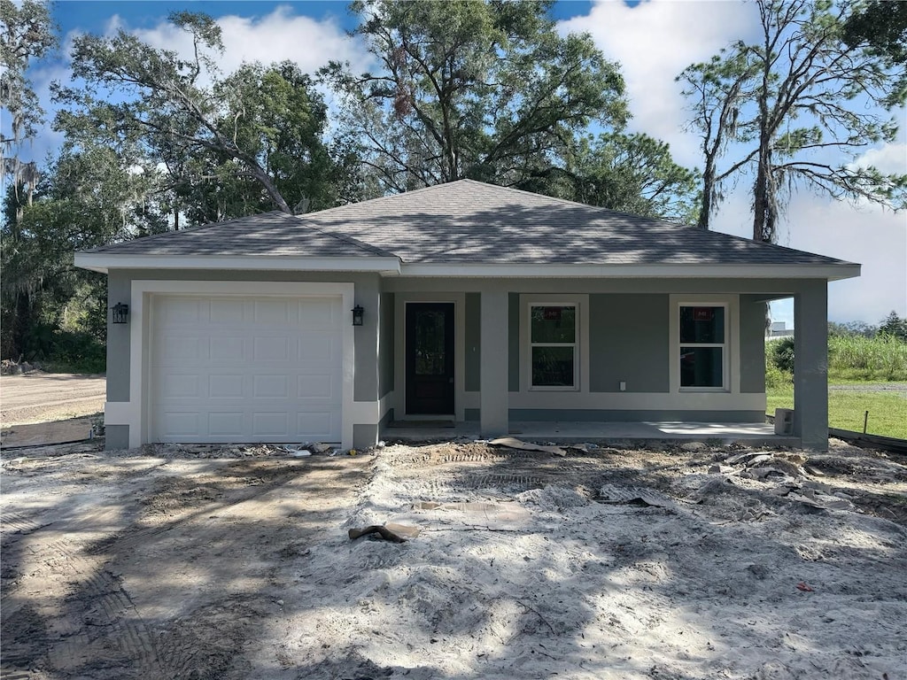 view of front of home with covered porch and a garage