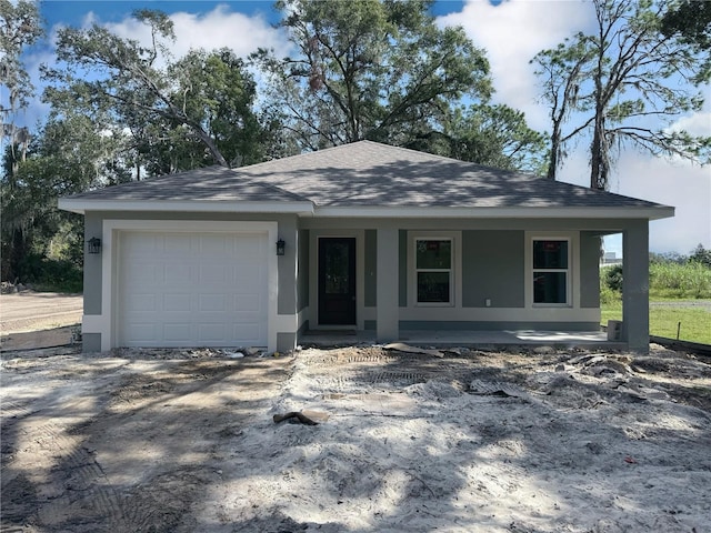 view of front of home with covered porch and a garage