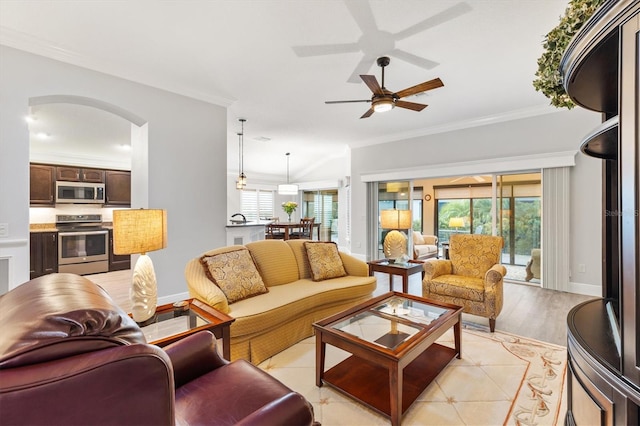 living room featuring ceiling fan, light hardwood / wood-style floors, and crown molding