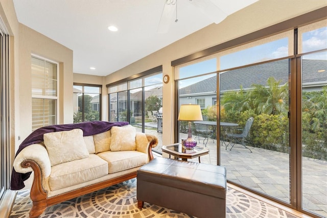 sunroom featuring ceiling fan