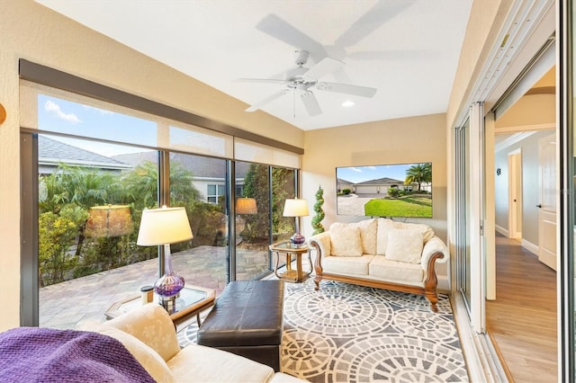 sunroom featuring ceiling fan