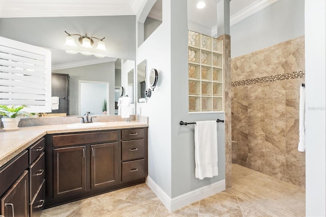 bathroom featuring a tile shower, vanity, tile patterned floors, and ornamental molding