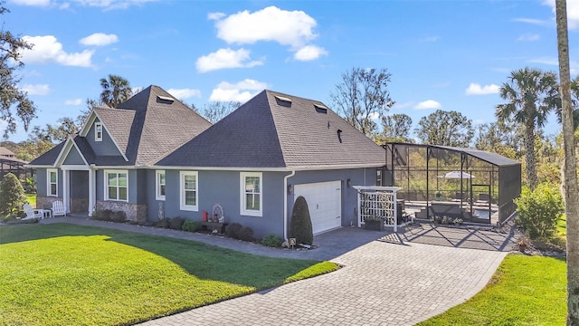 view of front of house with a garage and a front lawn