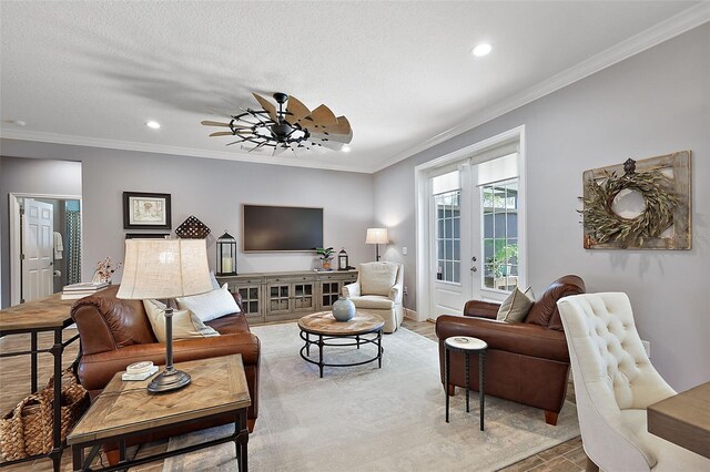 living room featuring a textured ceiling, ceiling fan, crown molding, and french doors