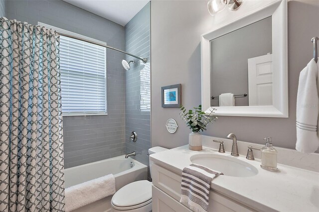 full bathroom featuring vanity, toilet, and shower / tub combo with curtain