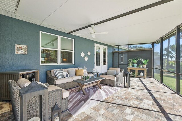 sunroom / solarium featuring ceiling fan and french doors