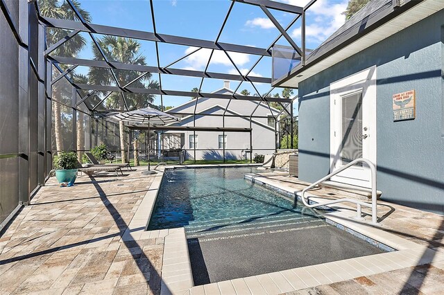 view of pool with a patio area and a lanai