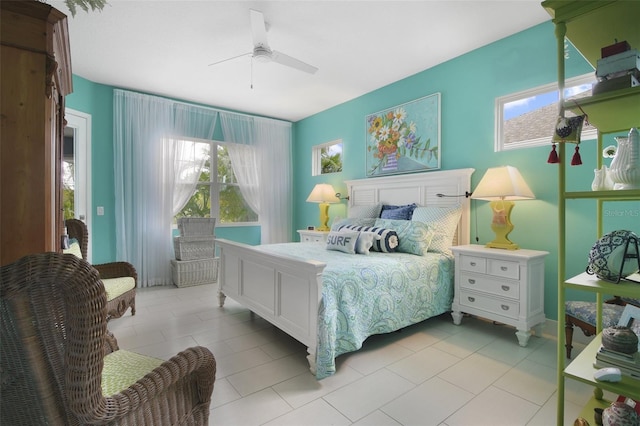 tiled bedroom featuring ceiling fan