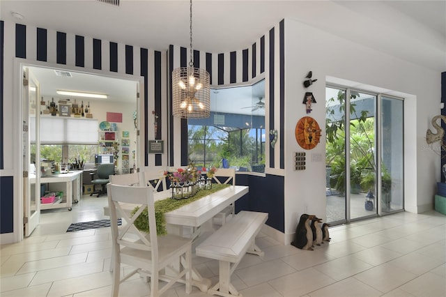 dining room with light tile patterned floors and a chandelier