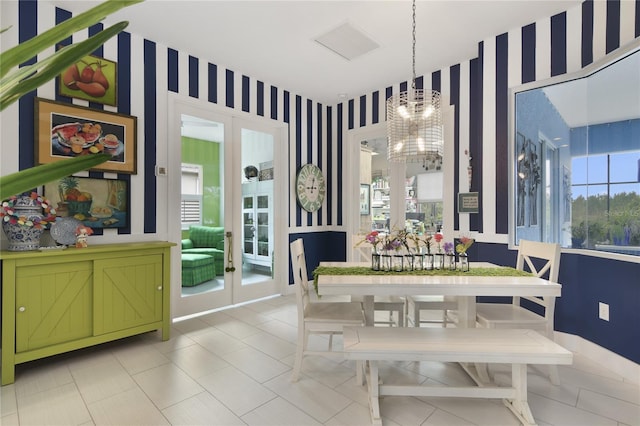 dining room featuring french doors and a chandelier