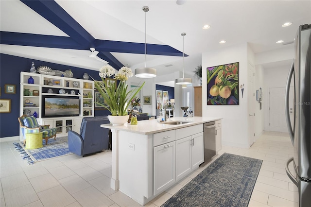 kitchen with stainless steel appliances, a kitchen island with sink, sink, white cabinets, and hanging light fixtures