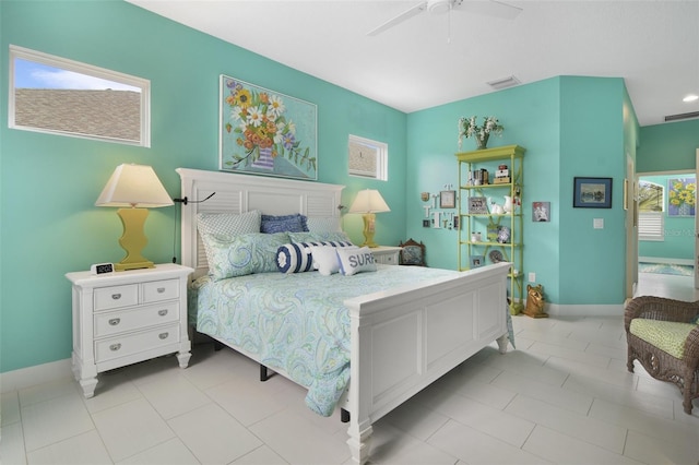 bedroom with ceiling fan and light tile patterned floors