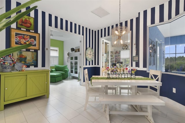 dining area featuring ceiling fan with notable chandelier and plenty of natural light