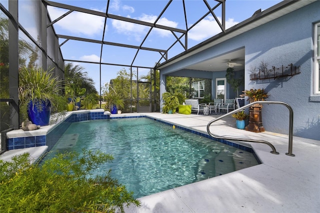 view of pool with a patio, ceiling fan, and a lanai