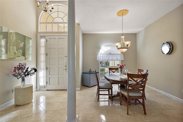 dining area with a chandelier and light tile patterned flooring