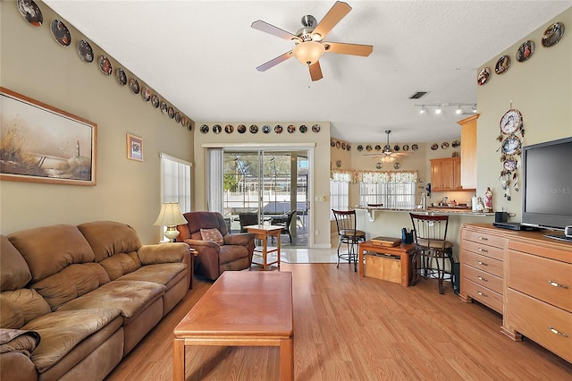 living room featuring ceiling fan and light wood-type flooring