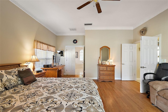 bedroom with ceiling fan, ornamental molding, ensuite bathroom, and light hardwood / wood-style flooring