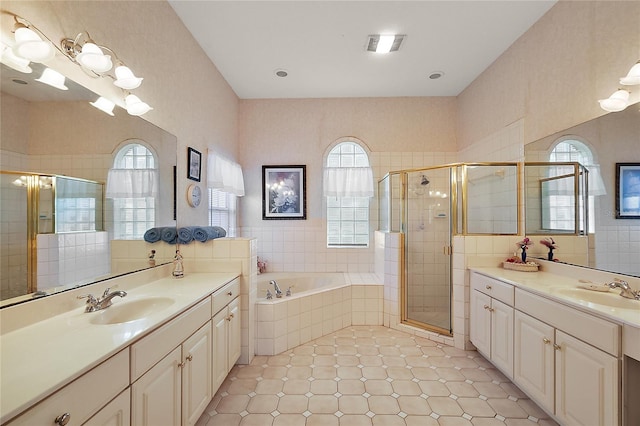 bathroom featuring vanity and plus walk in shower