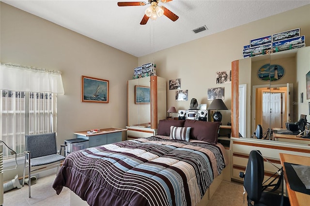 bedroom with a textured ceiling and ceiling fan