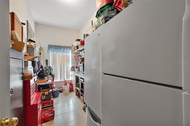 kitchen with white fridge and light tile patterned floors