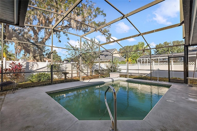 view of swimming pool featuring a lanai and a patio